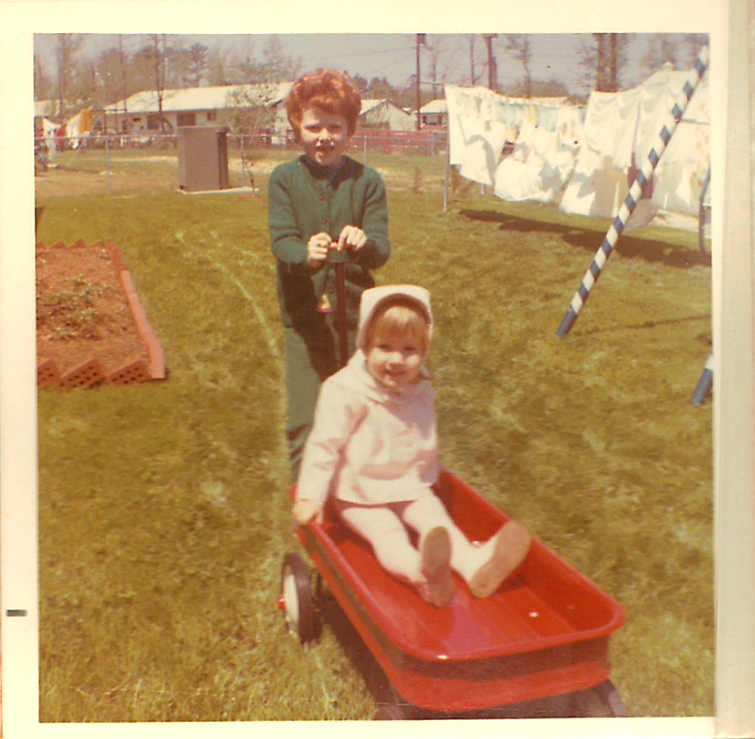 Audrey in the little red wagon & The Redhead Riter pulling it