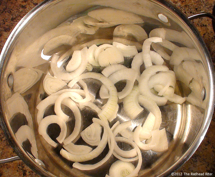 sliced onions in bottom of pot