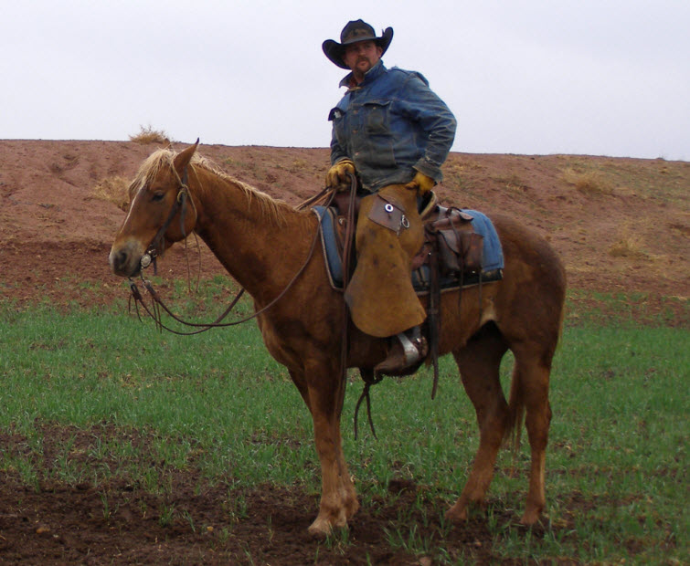 tough cowboy sitting on horse
