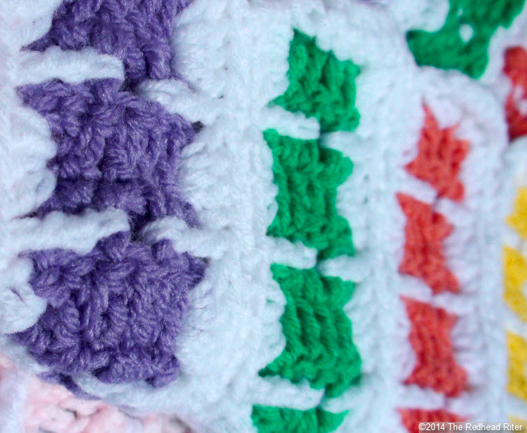crocheted afghan multi color stripe blocks closeup