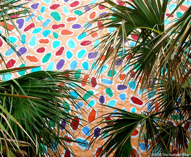 palm trees with painted art multi color circular shapes within circle